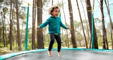 Little girl jumping on elastic bed
